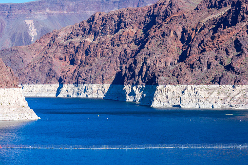 Record low water level of Lake Mead, key reservoir along Colorado River, during severe drought in the American West. Exposed bathtub ring.