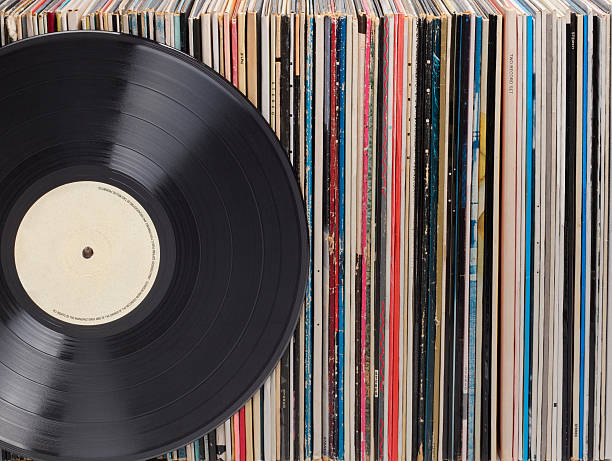 Records in a row, one in front Vinyl records in a row. One record is standing in front. On the record label there is some copy space. collection stock pictures, royalty-free photos & images