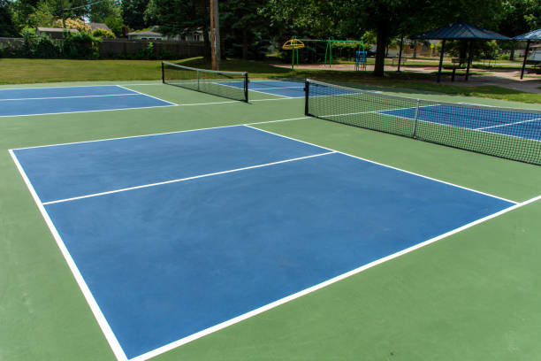Recreational sport of pickleball court in Michigan, USA looking at an empty blue and green new court at a outdoor park. stock photo