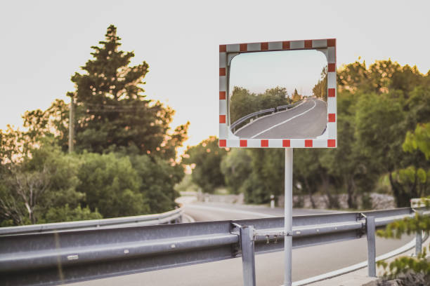 Rectangular road mirror on a curve stock photo