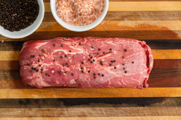 Rectangular slice of steak covered with pepper stock photo