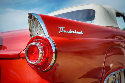 Westlake, TX, USA - October 17, 2015: A red 1956 Ford Thunderbird Convertible classic car is on display at the 5th Annual Westlake Classic Car Show. Tail fin and taillight details.