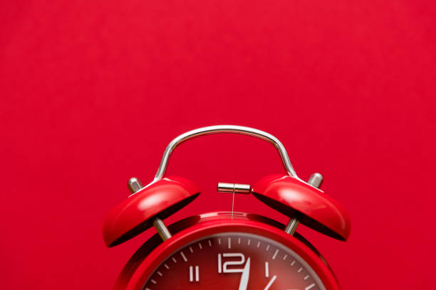 Red alarm clock on red background stock photo