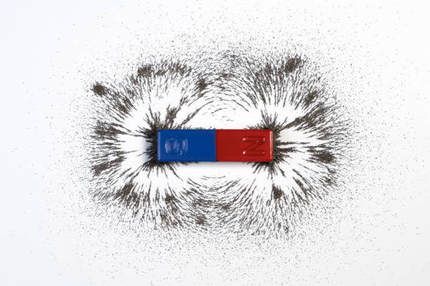 Red and blue bar magnet or physics magnetic with iron powder magnetic field on white background. Red and blue bar magnet or physics magnetic with iron powder magnetic field on white background. Scientific experiment in science class in school. magnet stock pictures, royalty-free photos & images