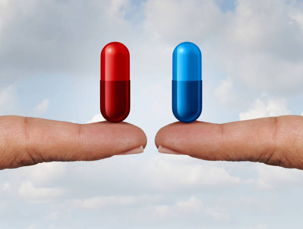 Red And Blue Pill Red and blue pill choice as fingers holding medication capsules as a symbol of choosing between truth and illusion or knowledge or ignorance or pharmaceutical treatment option concept with a 3D render. generic drug stock pictures, royalty-free photos & images