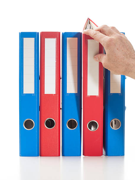Red and blue ring binders with hand stock photo