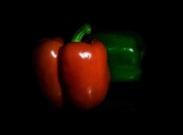 Red and green peppers (low key) stock photo