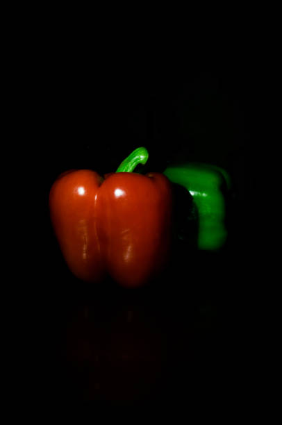Red and Green peppers (Low key) stock photo