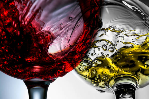 Red and white wine splash in wineglasses close-up macro. stock photo