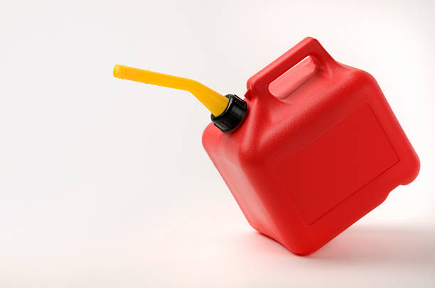 Red and Yellow Gas Can Tipping With Clipping Path stock photo