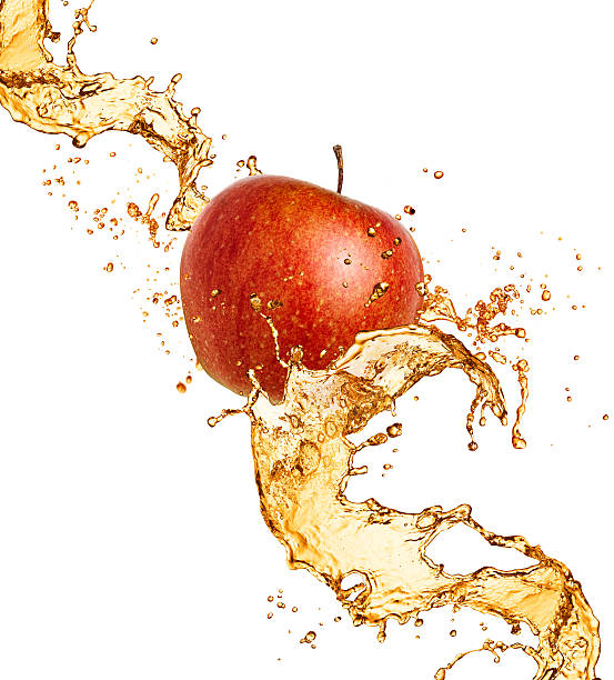Red apple in juice splash stock photo