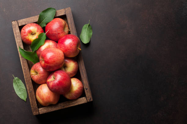 Red apples in wooden box Ripe red apples in wooden box. Top view with space for your text apple fruit stock pictures, royalty-free photos & images