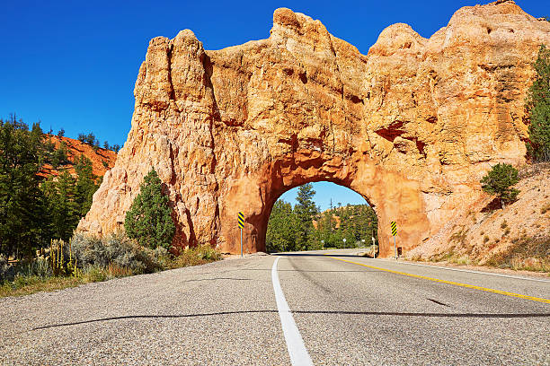 Red Arch road tunnel near Bryce Canyon National Park Red Arch road tunnel on the way to Bryce Canyon National Park, Utah, USA bryce canyon national park stock pictures, royalty-free photos & images