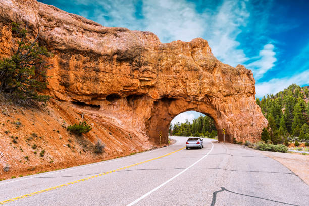 Red Arch road tunnel to Bryce Canyon Car going through Red Arch road tunnel to Bryce Canyon. Utah, USA bryce canyon stock pictures, royalty-free photos & images