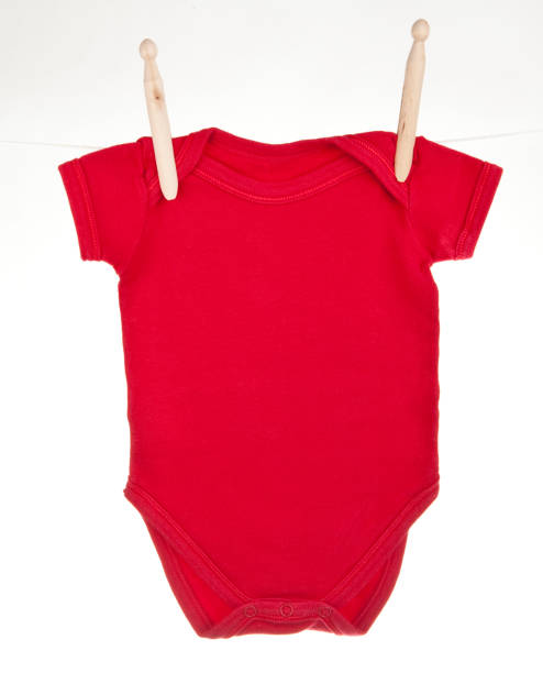 Red baby bodysuit hanging on a clothesline stock photo