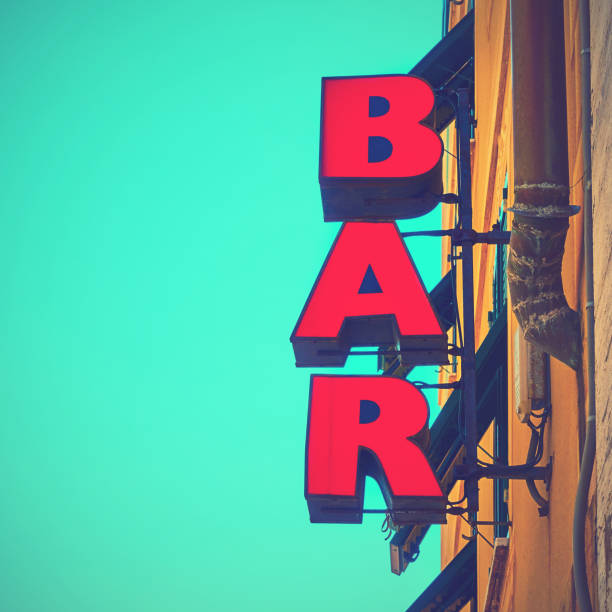 Red bar sign Red bar sign on the wall close-up. Social media style filtered bar drink establishment stock pictures, royalty-free photos & images