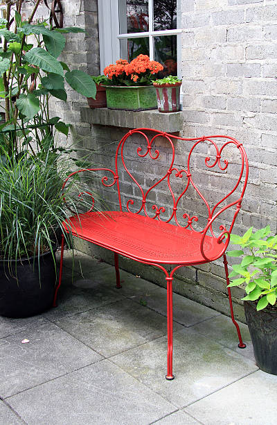 Red bench outside on a patio stock photo