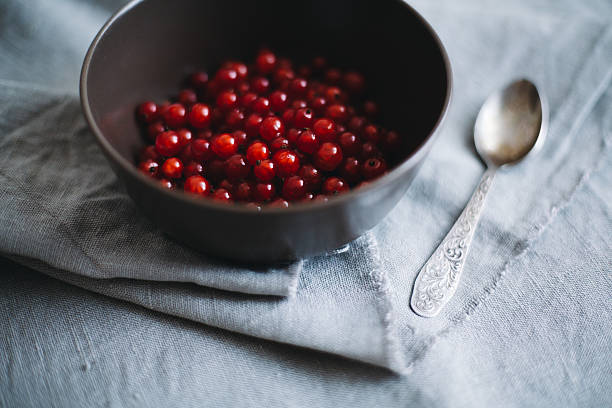 Red berries in a bowl stock photo