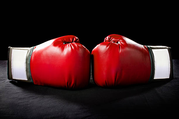 Red Boxing Gloves on a Black Background stock photo