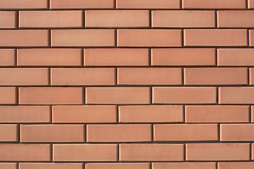 Geometric building background is a wall made of red brick.