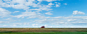 istock Red car driving on grassland highway 1365277852