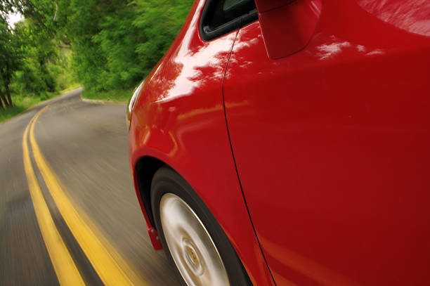 Red car in motion. Side view.  territorial animal stock pictures, royalty-free photos & images