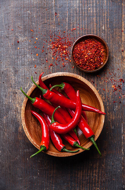 Red Chili Peppers Red Hot Chili Peppers in wooden bowl on dark wooden background cayenne pepper photos stock pictures, royalty-free photos & images