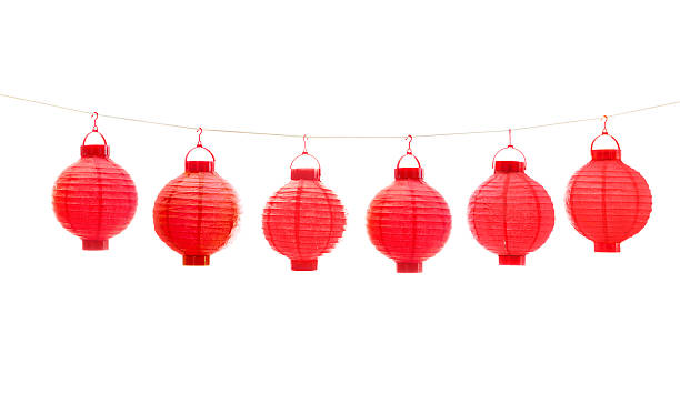 Subject: A row of red Chinese lanterns hanging on a string. Isolated on white background.