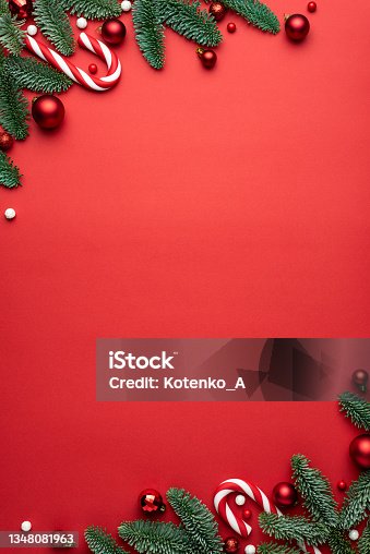 istock Red Christmas background with fir branches and decorations 1348081963