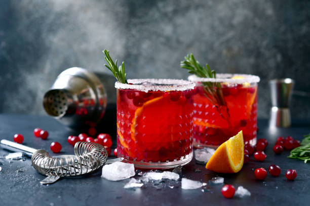 Red christmas cocktail with cranberries and oranges stock photo