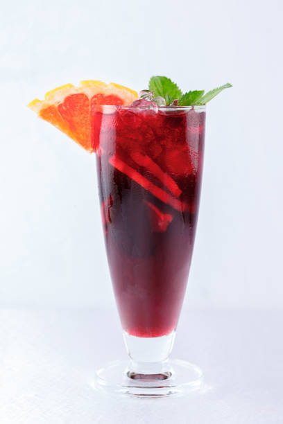 Red cocktail with orange, ice and mint stock photo