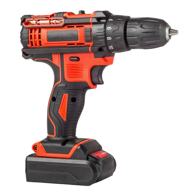 Red cordless drill with black decorative trim, screwdriver with battery isolated on a white background stock photo