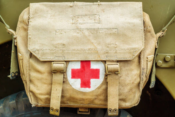 Red cross medical aid symbol on an old army bag stock photo