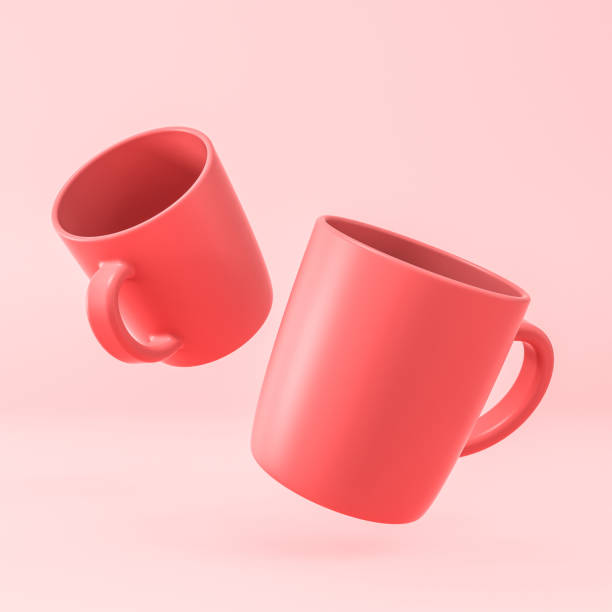 red cups on pink background. stock photo