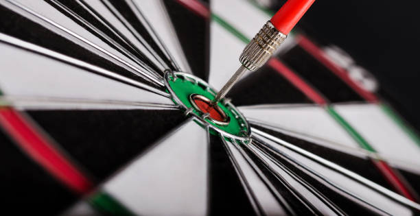 Red dart arrow on center of dartboard. Concept o business target, success and win. stock photo