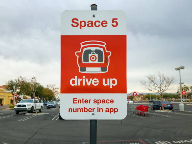 Red drive up deliver sign for Target Apple Valley, CA, USA – December 21, 2021: Red drive up deliver sign for Target retail store in Apple Valley, California. curbsidepickup stock pictures, royalty-free photos & images