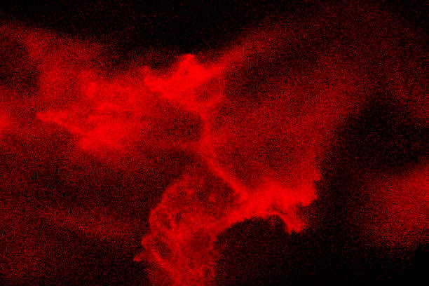 Photo of Red dust particles explosioon on black background.Red powder splash.