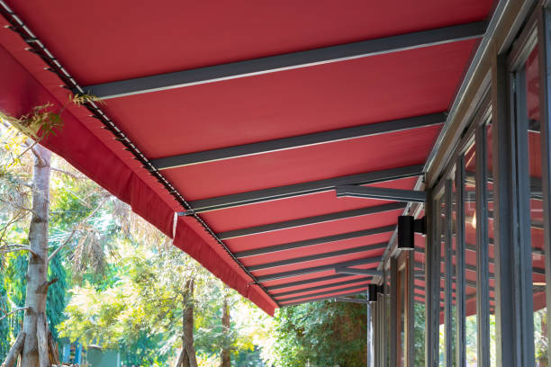 red fabric awning with steel structure roof of coffee shop in garden.  awning window stock pictures, royalty-free photos & images