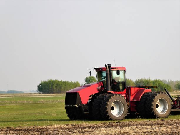 Red Farm Tractor in an Agricultural Field stock photo
