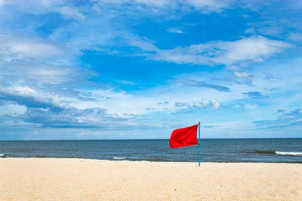 Red Flag Embroidered on the beach by the sea. stock photo