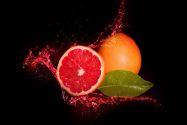 Red Grapefruit Inside Juice Splash stock photo