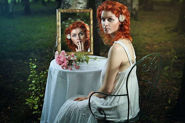 Red hair woman and strange mirror stock photo