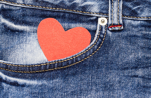 Red heart in a denim pocket. Valentine's card.