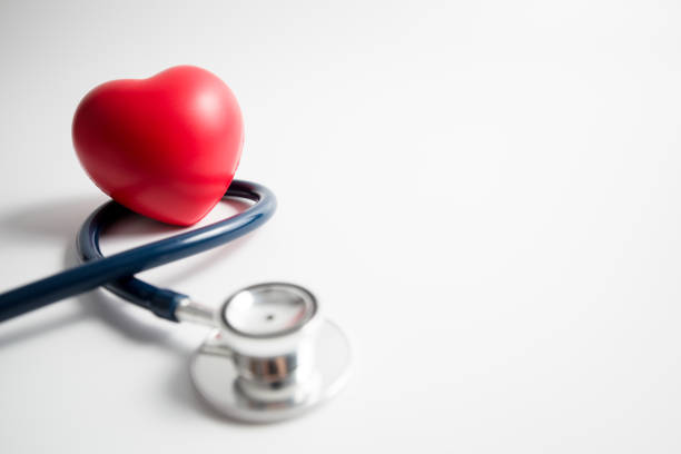Red heart with stethoscope on white background stock photo
