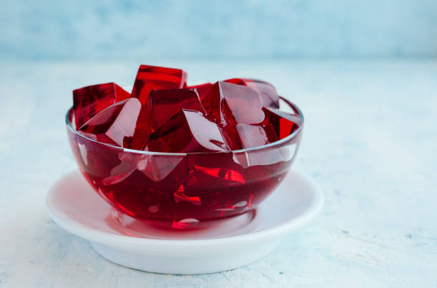 Red Jelly Cubes Cubes of red jelly in a glass bowl gelatin stock pictures, royalty-free photos & images