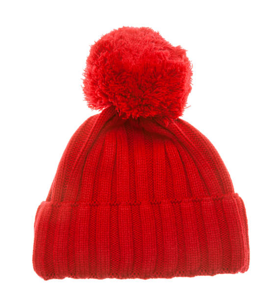 Red knit winter bobble hat isolated on white Red knitted winter bobble hat of traditional design isolated on white background. Handmade woolly cap with pompom on top knit hat stock pictures, royalty-free photos & images
