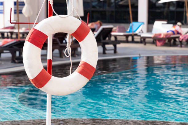 Red lifebuoy ring near the swimming pool. Rescue concept. stock photo