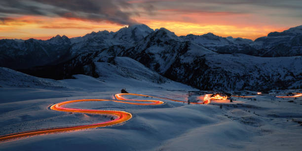Red light trails in a snowy winter landscape stock photo