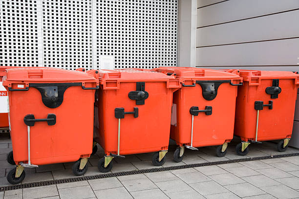 red modern trash containers in a row XL stock photo