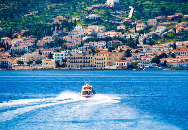 red motor boat transfer people to Spetses island, stock photo